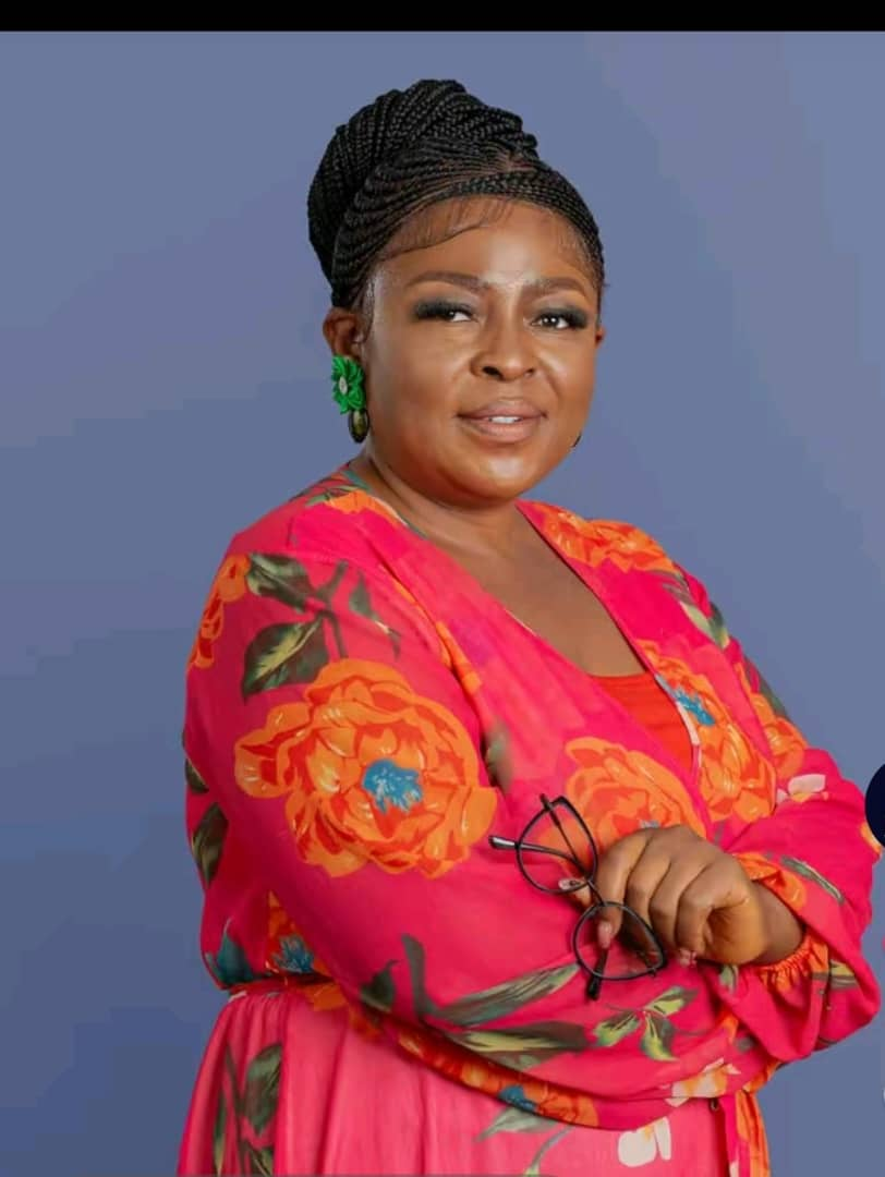 Mrs. Maurine Mbongeh Musi, Director of Partnerships at GHITS University, professional portrait in red floral dress